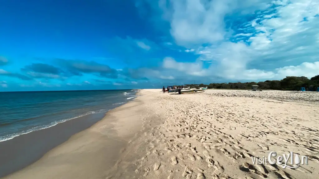 Baththalangunduwa Beach with clear blue water, white sand, and peaceful island scenery.
