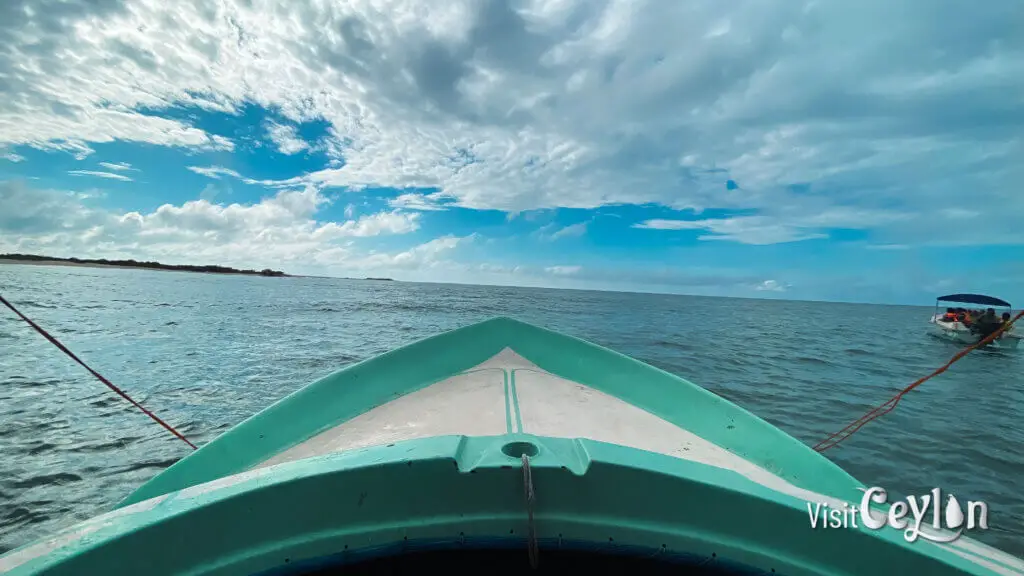 A boat ride to Baththalangunduwa with travelers moving across calm ocean waters.