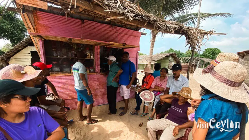 Small village shop surrounded by houses and greenery.