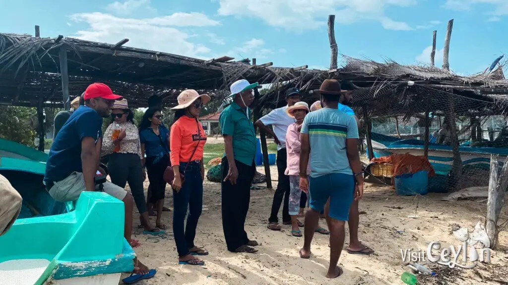 Village fishing boat docked by the shore with calm water.