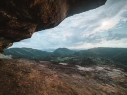 Scenic view from inside Nuwaragala cave, Sri Lanka
📷 Photo Credit: Sameera Marapperuma | Visit Ceylon View from inside Nuwaragala cave showing forested landscape and distant mountains, Sri Lanka.